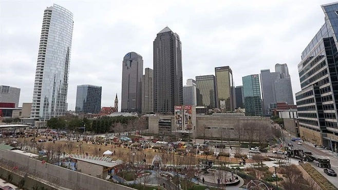 Dallas’ Klyde Warren Park houses community events, such as this Jeff Gordon day in 2015. First-time visitors might not realize at first that the park was built on a deck constructed across a freeway, part of a trend of cities nationwide building “highway cap parks” to bring more green space to downtowns.