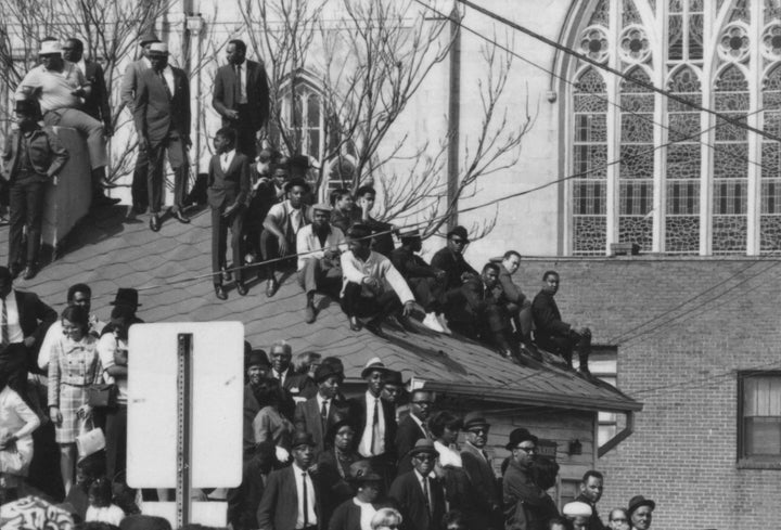 Onlookers crowding a rooftop in Atlanta on the day of MLK's funeral.