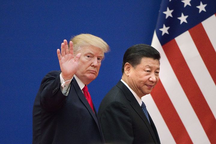 U.S. President Donald Trump (L) and China's President Xi Jinping leave a business leaders event at the Great Hall of the People in Beijing on November 9, 2017. (NICOLAS ASFOURI/AFP/Getty Images)