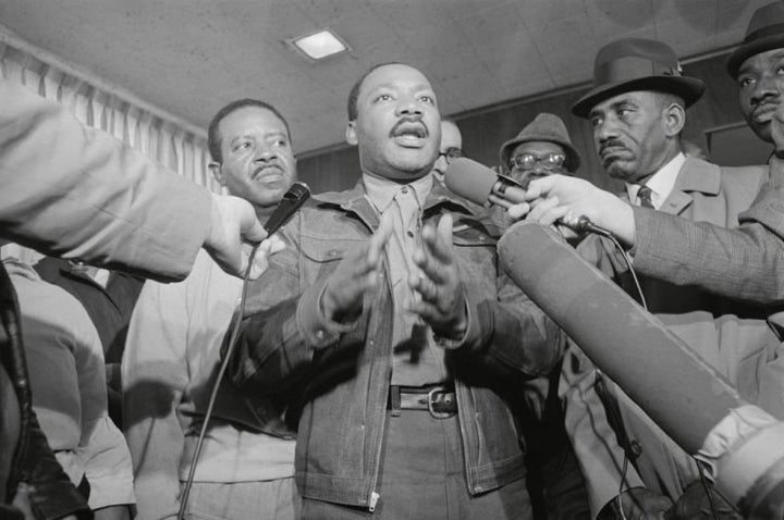 King and the Rev. Ralph Abernathy, left, are met by reporters as they emerge from the Jefferson County jail in Birmingham, Ala., on Nov. 6, 1967. 