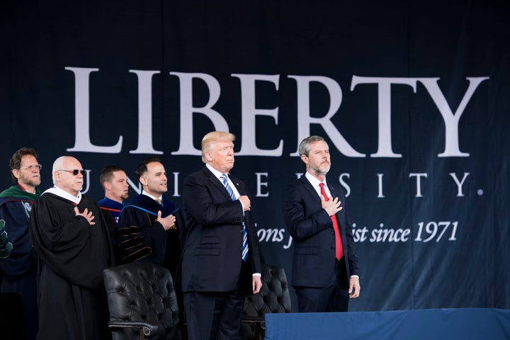 President Donald Trump stands with Jerry Falwell Jr., right, the president of Liberty University, during the evangelical Christian college's commencement ceremony on May 13, 2017, in Lynchburg, Virginia.