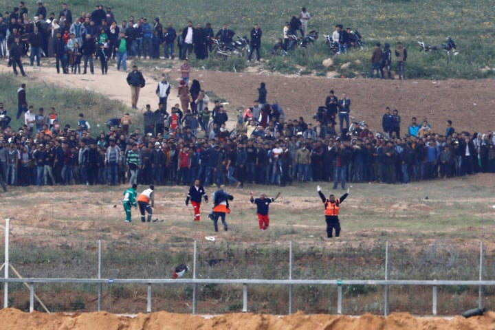 Palestinian paramedics evacuate an injured man on the Gaza side of the Israel-Gaza border on Friday.