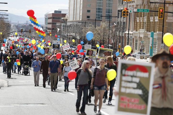 People march in downtown Salt Lake City on March 30, 2018. The protesters demanded that the Mormon church change its policy o