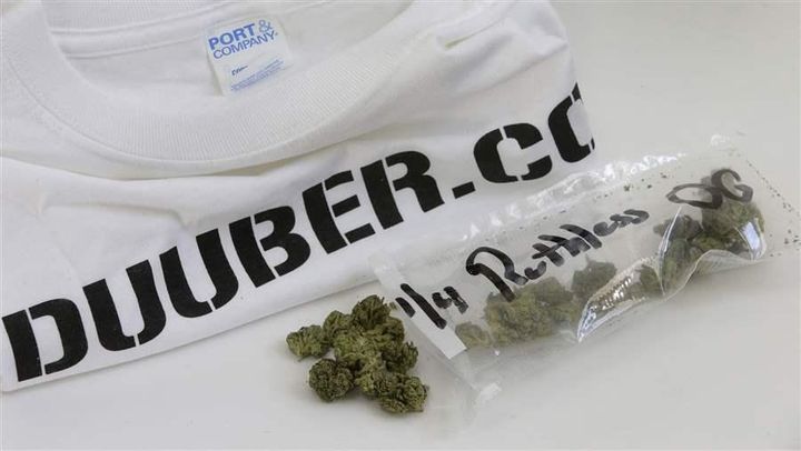 Marijuana and a T-shirt from Massachusetts pot delivery company Duuber.com. Companies like Duuber exploit loopholes in state law that allow people to give away or “gift” up to an ounce of marijuana. The Duuber T-shirt cost $100 but the marijuana was a gift.