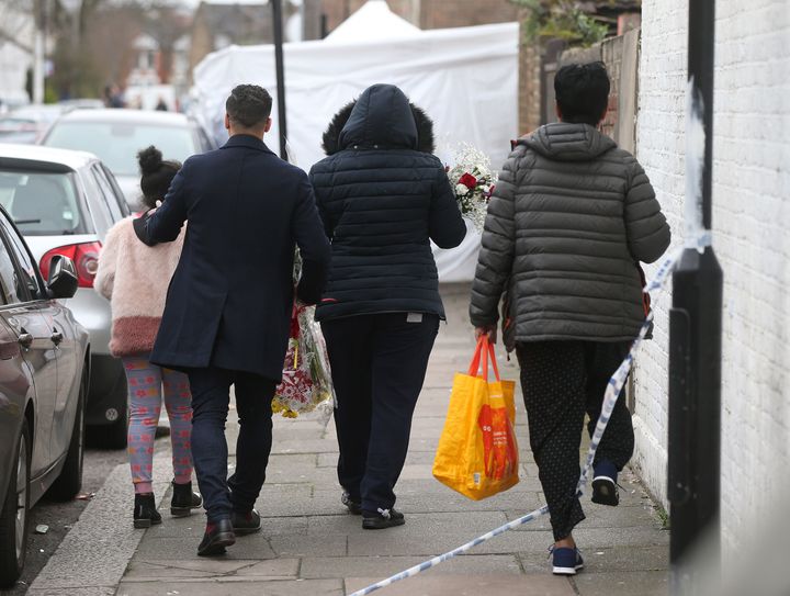 People thought to be friends and family lay flowers at the scene Chalgrove Road in Tottenham, north London, where a 17-year-old girl died after she was shot on Monday evening.