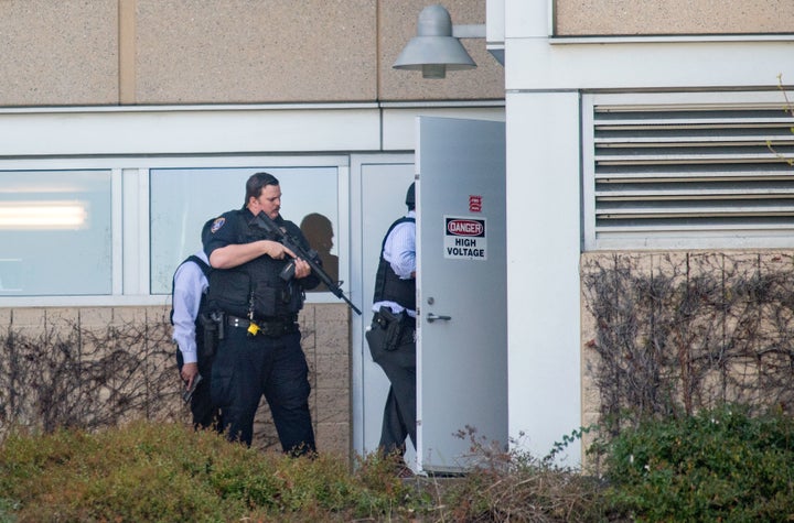 Police search a building at YouTube's corporate headquarters.