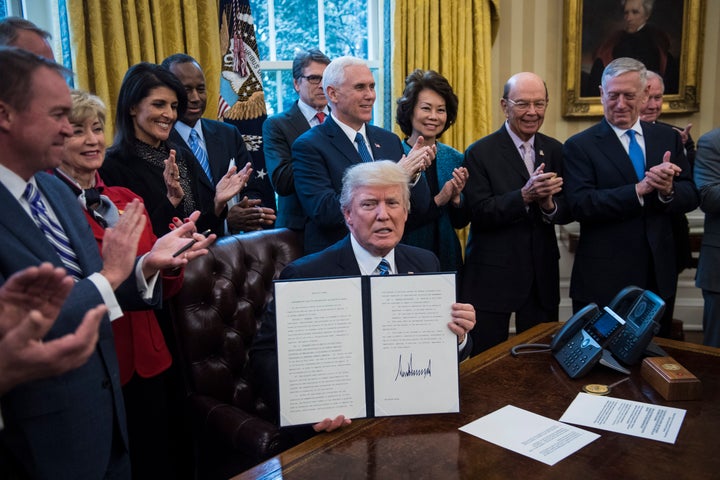 Trump surrounded by members of his cabinet in March 2017.