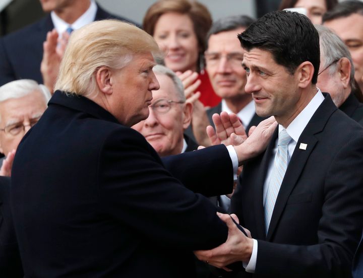 President Donald Trump shakes hands with House Speaker Paul Ryan (R-Wis) as Republicans celebrate the passage of a sweeping tax cut bill last December.