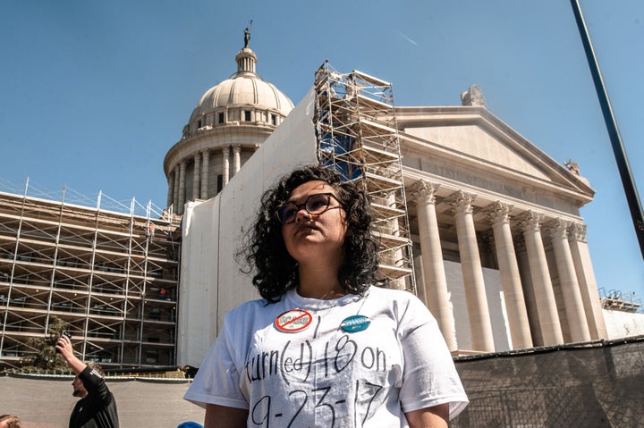 Gabrielle Davis, a senior at Edmond Memorial Highschool, stands in front of the Oklahoma state capitol on the third day of a statewide teacher walkout.