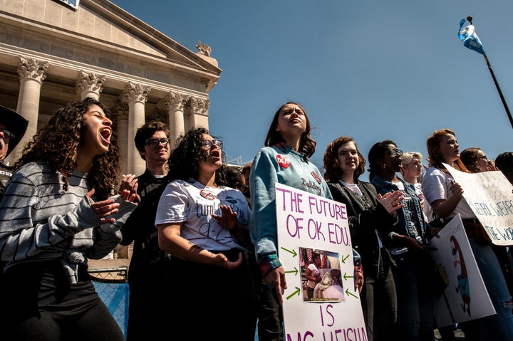 Students stand on stage in front of the Oklahoma state capitol building on the third day of a statewide teacher walkout.