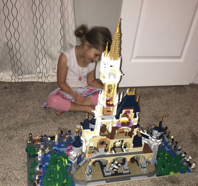 The author's middle daughter, 4 at the time the photo was taken, playing with a new Disneyland Lego castle in a custom Disneyland scene.