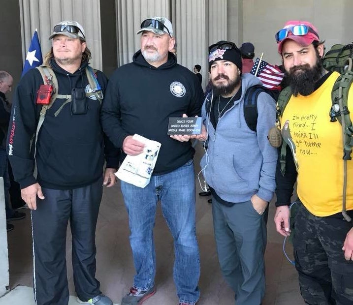 From right, Adam Lingo and Eddie Montoya pose for a photo with fellow Deuce-Four veterans at the end of their "Walk of Life" in Washington D.C. The veterans are holding a stone, inscribed with their infantry unit, that was set to be placed in a wall at the Department of Veteran Affairs. 