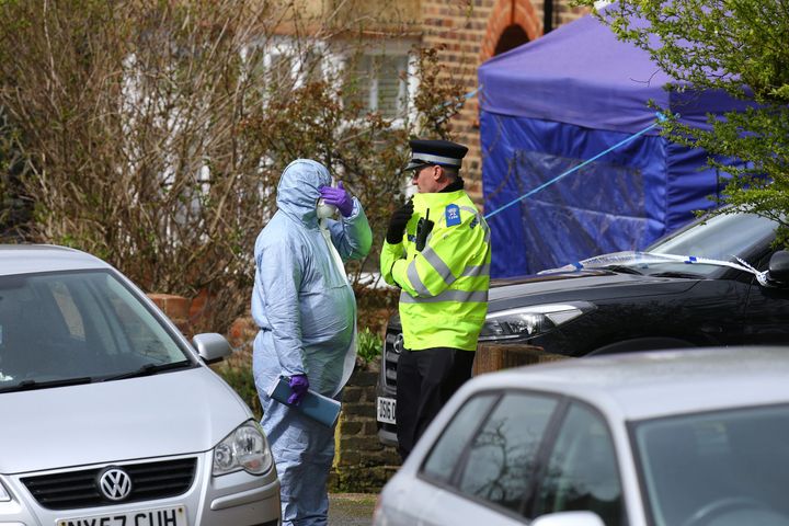 A police officer, a forensic officer and a forensic tent in South Park Crescent