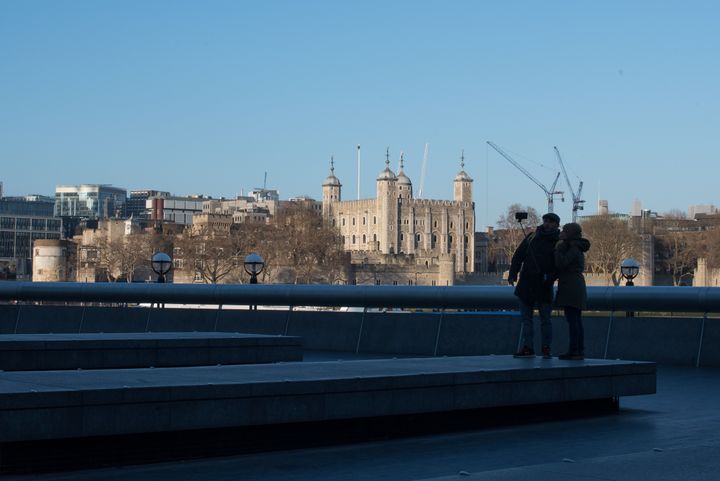Temperatures are expected to be in the double-digits for most parts of the UK today and Friday; a couple is seen above taking a selfie near the Tower of London earlier this month 