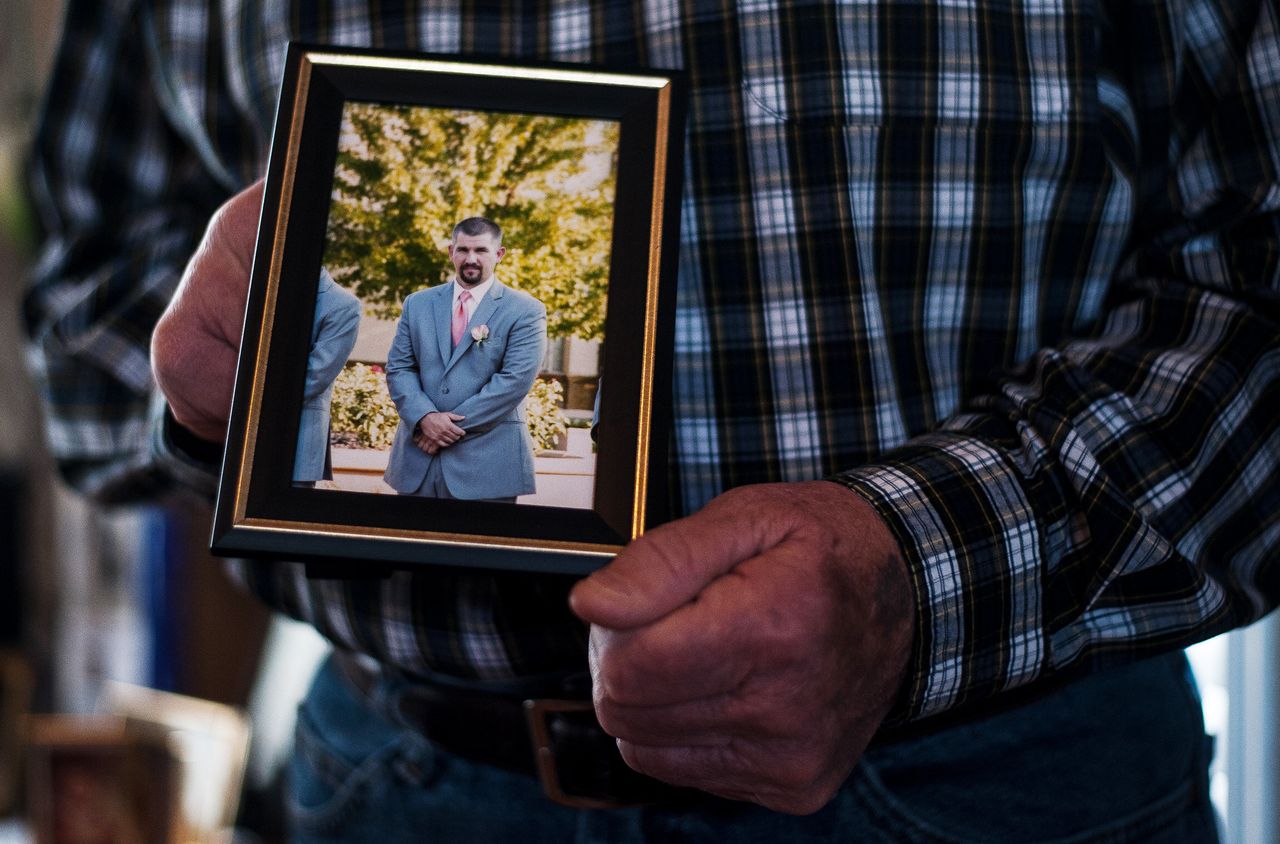 Bob Arthur holds a photo of his son, Shawn Arthur. 