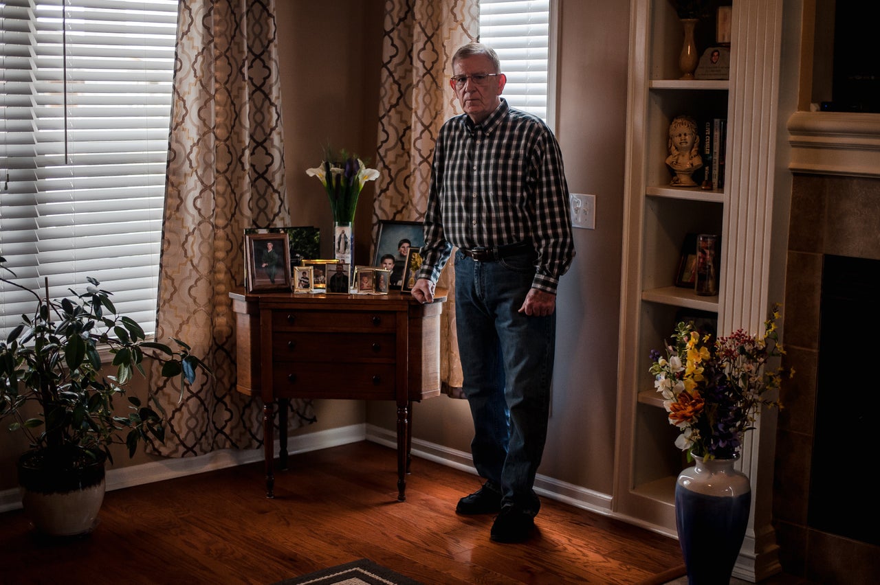 Bob Arthur in his Missouri home next to a memorial for his son Shawn Arthur.