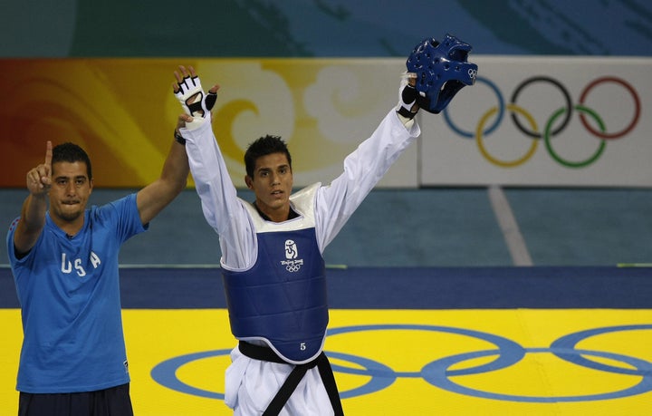 Coach Jean Lopez (left) and his brother Steven Lopez celebrate winning the bronze medal in the men's 80KG taekwondo 