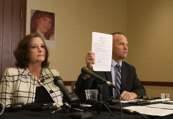 Attorney Craig Vernon holds up the results of his client McKenna Denson's lie detector test. Denson is suing the Church of Jesus Christ of Latter-day Saints for its handling of her rape allegations.