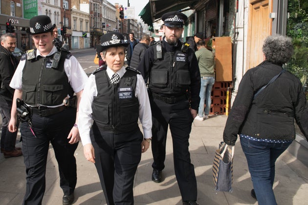 Met Police Commissioner Cressida Dick walks with officers in Stoke Newington, north London, on Friday