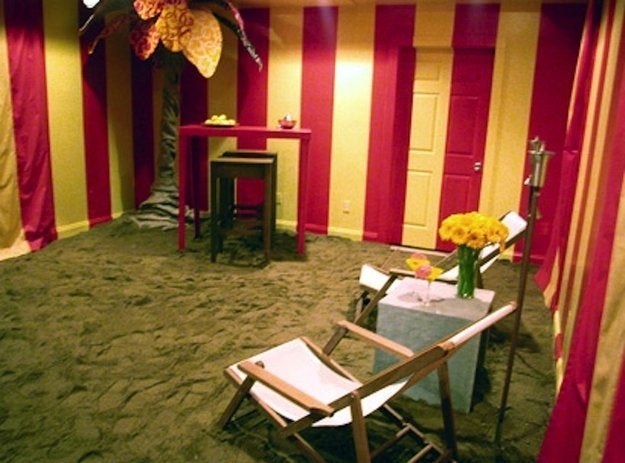 Hildi Santo-Tomas covered a living room floor with sand for a beach getaway theme.