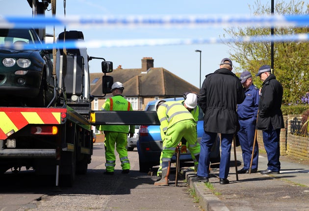 Forensic officers investigate the drains near the scene in South Park Crescent.