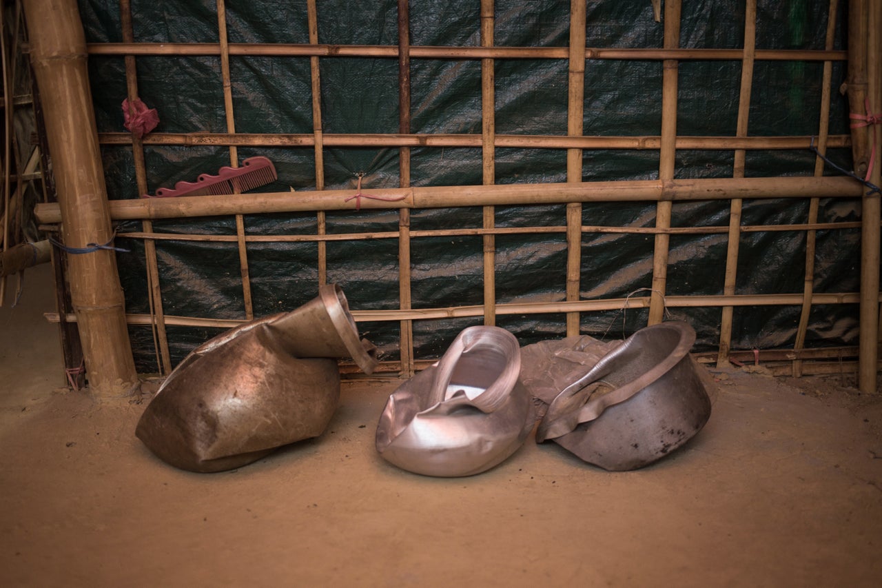 TOP PHOTO: Anwar Begum shows a water pot smashed by an elephant that trampled her family's hut in Kutupalong refugee camp in Bangladesh. Her husband, Yakub Ali, died in the incident. ABOVE: More of the smashed pots at Begum's hut.