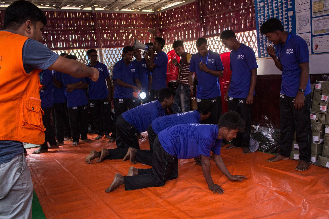 Volunteers take part in a patrolling drill during elephant response training at Kutupalong refugee camp in March.