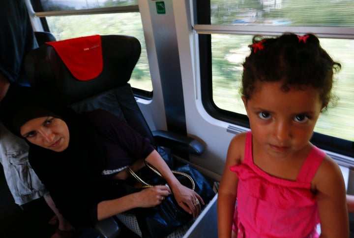 A woman with her daughter aboard a train from Budapest to Vienna on Aug. 31, 2015.