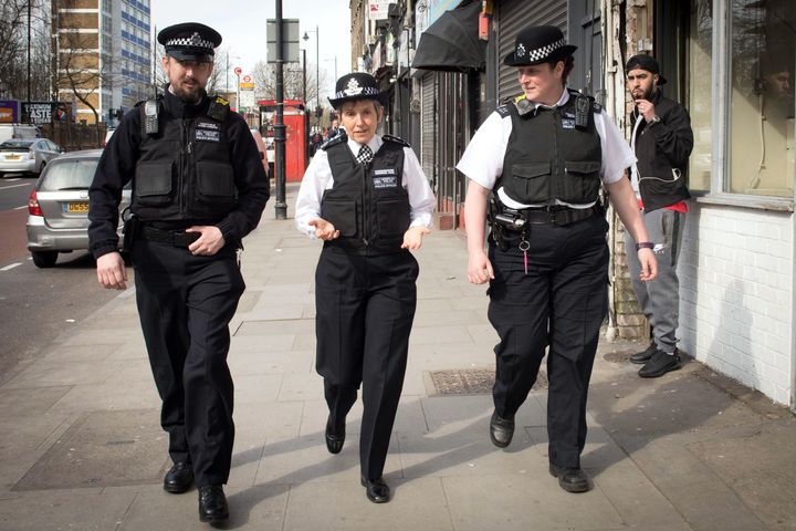 Metropolitan Police Commissioner Cressida Dick (centre) walks with officers through Stoke Newington in north London, after a recent spate of gang violence in which several teenagers died.