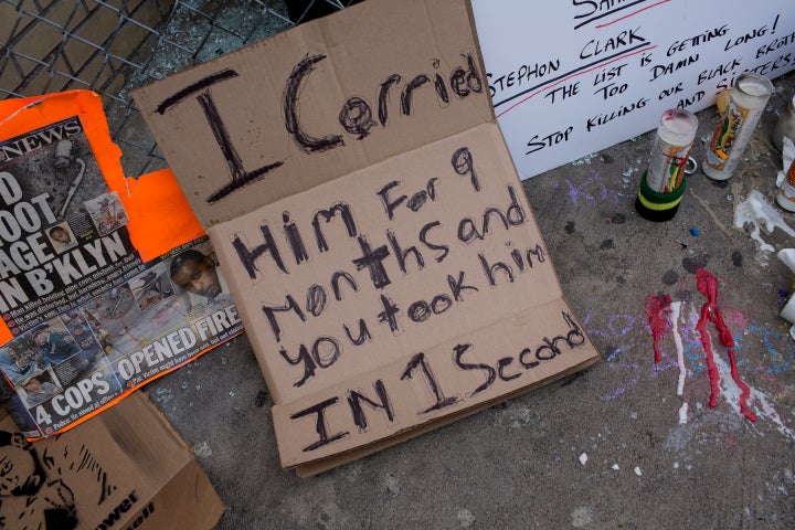 Posters and candles on April 5 at the location where police officers shot and killed Saheed Vassell in the New York
