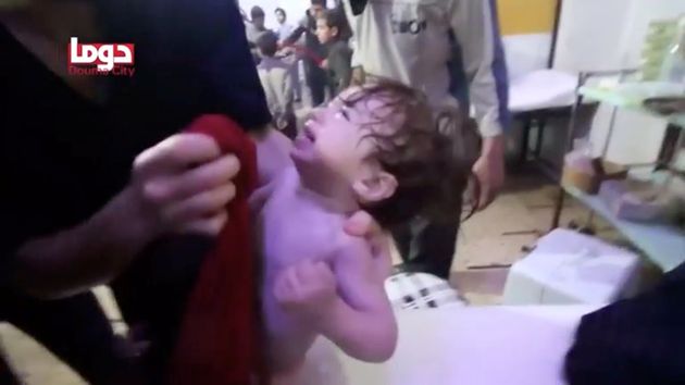 A child cries as they have their face wiped following alleged chemical weapons attack, in what is said to be Douma, Syria, in this still image from video obtained by Reuters on April 8, 2018. 