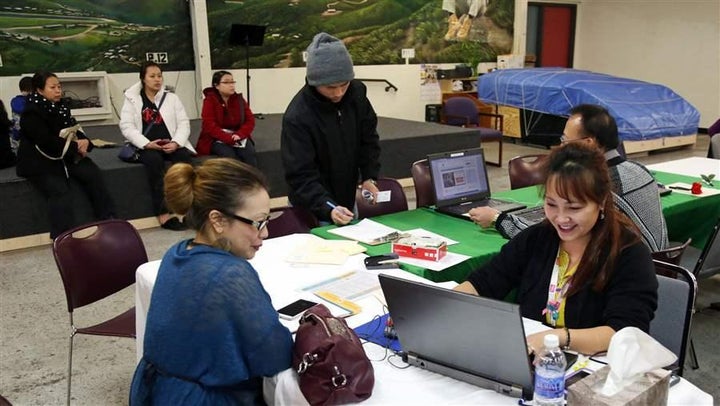 <p>A woman signs up for health insurance on Minnesota’s exchange, MNsure, in St. Paul. The state’s reinsurance pool has helped reduce premiums on the exchange by 15 percent in 2018.</p>