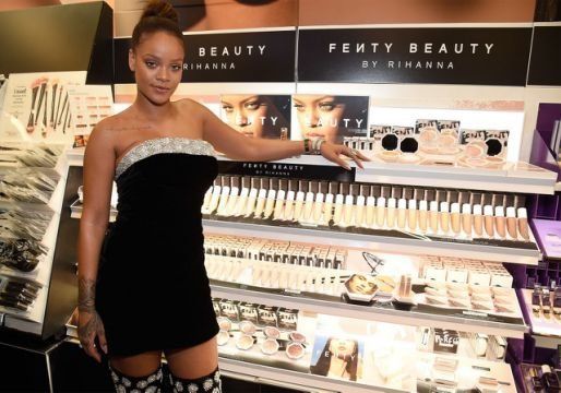 Rihanna with a display of her namesake makeup line, Fenty Beauty. 