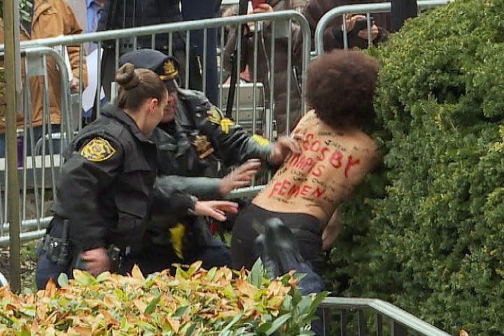 Officers detain protester Nicolle Rochelle at the Montgomery County courthouse in Norristown, Pennsylvania, on April 9, 2018.