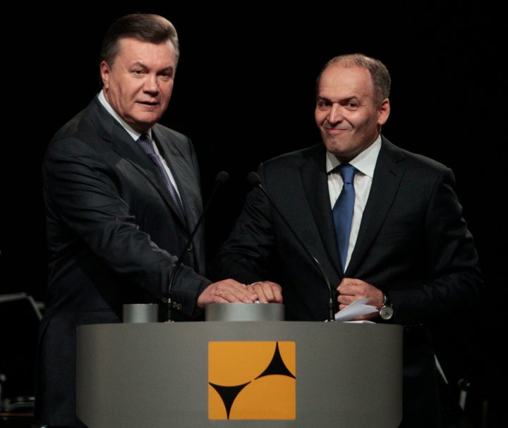 Ukraine's former president Viktor Yanukovych and tycoon Viktor Pinchuk take part in a ceremony to open a new steel mill on Oct. 4, 2012.