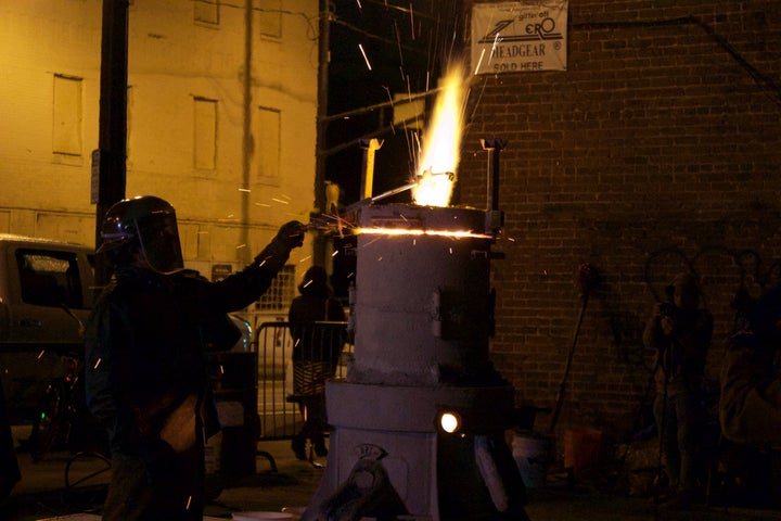 A firearm is melted over a furnace in a guns-to-shovels ceremony last week in Atlanta.