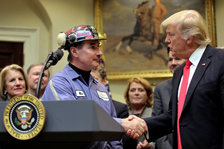 Michael Nelson, a coal miner worker, shakes hands with President Donald Trump as he prepares to sign Resolution 38, which nullifies the "stream protection rule," at the White House.