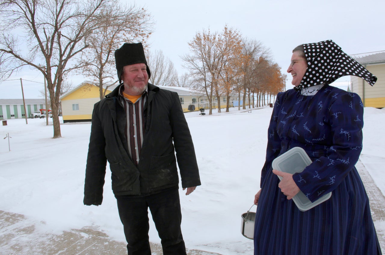 Hutterite women wear patterned head coverings.