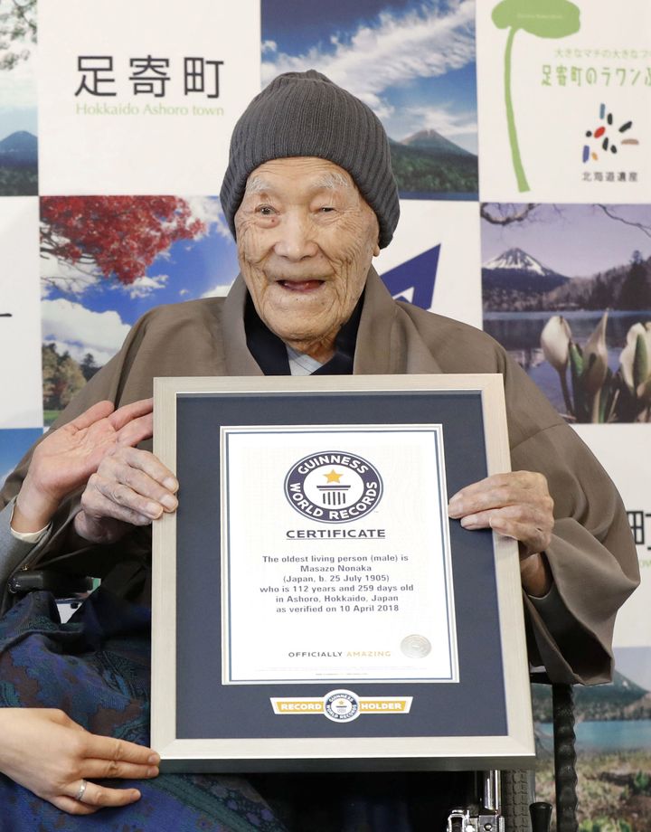 Masazo Nonaka, who was born 112 years and 259 days ago, receives a Guinness World Records certificate naming him the world's oldest man during a ceremony in Ashoro, on Japan's northern island of Hokkaido, on Tuesday.