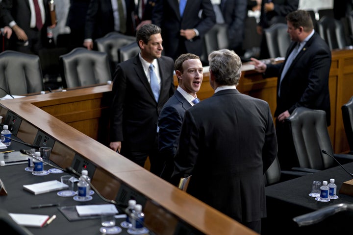 Zuckerberg and Kennedy shake hands and speak to each other following the hearing.