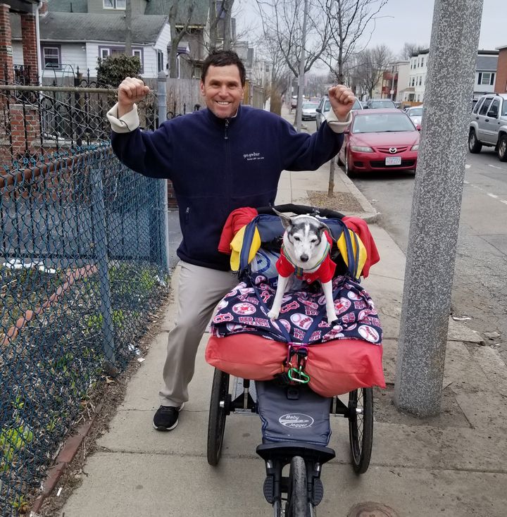 Carlos Arredondo, who aided victims of the Boston Marathon bombings in 2013, works out with his 18-year-old canine training partner and support animal, Buddy. He'll be running the marathon Monday.