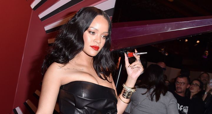 Rihanna holding up her Stunna lip paint. 