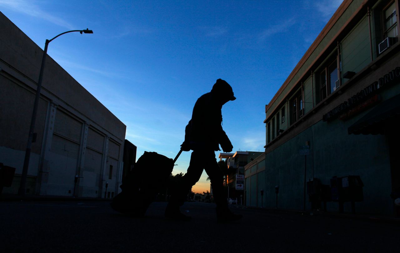 A homeless person makes his way down Los Angeles' Hollywood Boulevard one morning in February 2012.