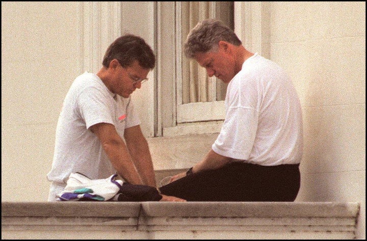 President Bill Clinton prays with Bill Hybels on the North Portico of the White House after a morning jog on June 6, 1995.