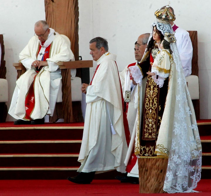 The bishop of Osorno, Juan Barros (center), takes part in an open-air mass celebrated by Pope Francis (left) at Maquehue airport in Temuco on Jan. 17, 2018.