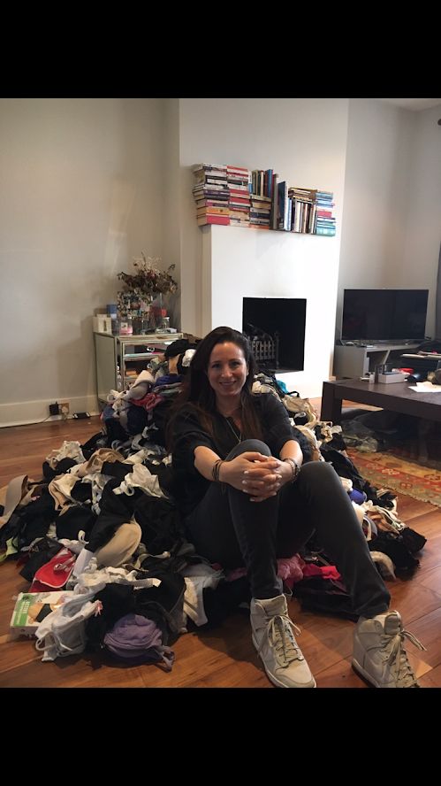 Emma Sinclair sits on a mountain of bras.