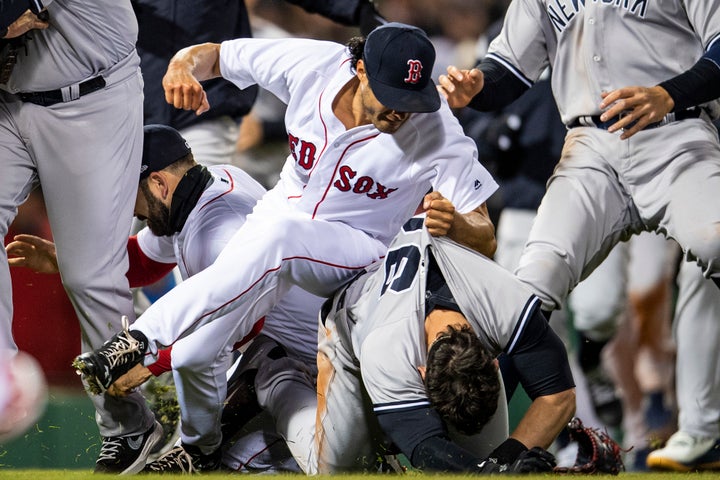 Joe Kelly #56 of the Boston Red Sox clenches his fist and grabs the jersey of Tyler Austin #26 of the New York Yankees.