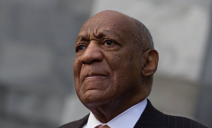Bill Cosby stands next to his spokesman, Andrew Wyatt, as Wyatt addresses media on Tuesday.
