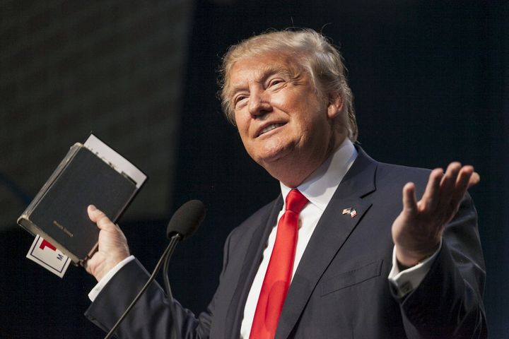 Then-candidate Donald Trump holds a Bible while speaking at the Iowa Faith and Freedom Coalition Forum in Des Moines, Iowa, in September 2015.