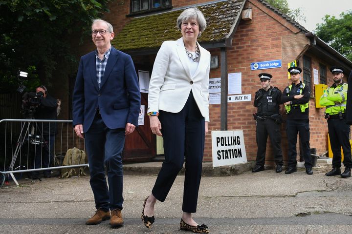  Theresa May and her husband Philip leave after casting their votes in the General Election at a polling station in the village of Sonning, Berkshire